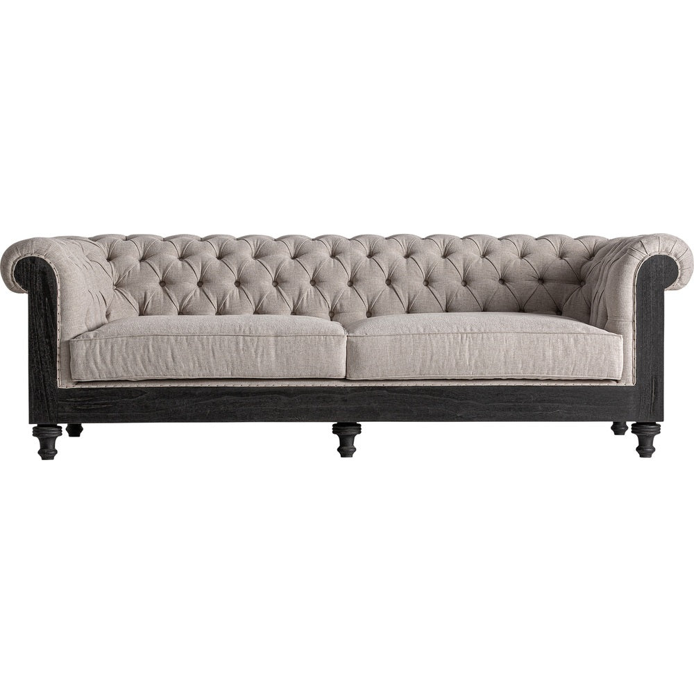 Divano Colonial Luxury in lino beige con struttura in legno nero e lavorazione capitonné.